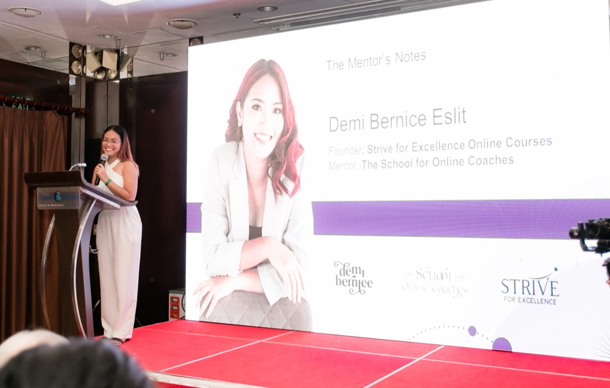 Demi speaking on stage as mentor of The School for Online Coaches