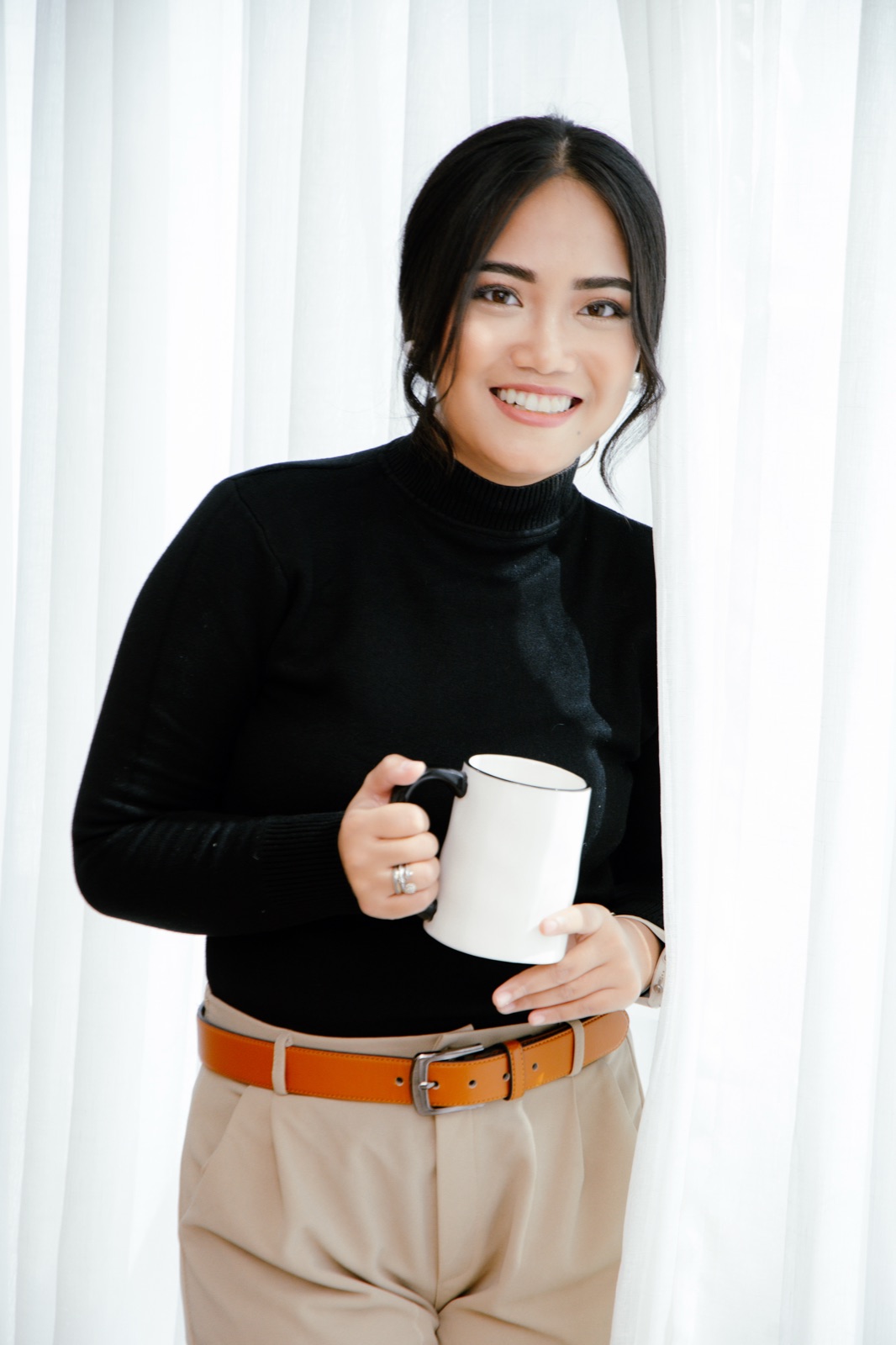 Demi holding a mug and smiling